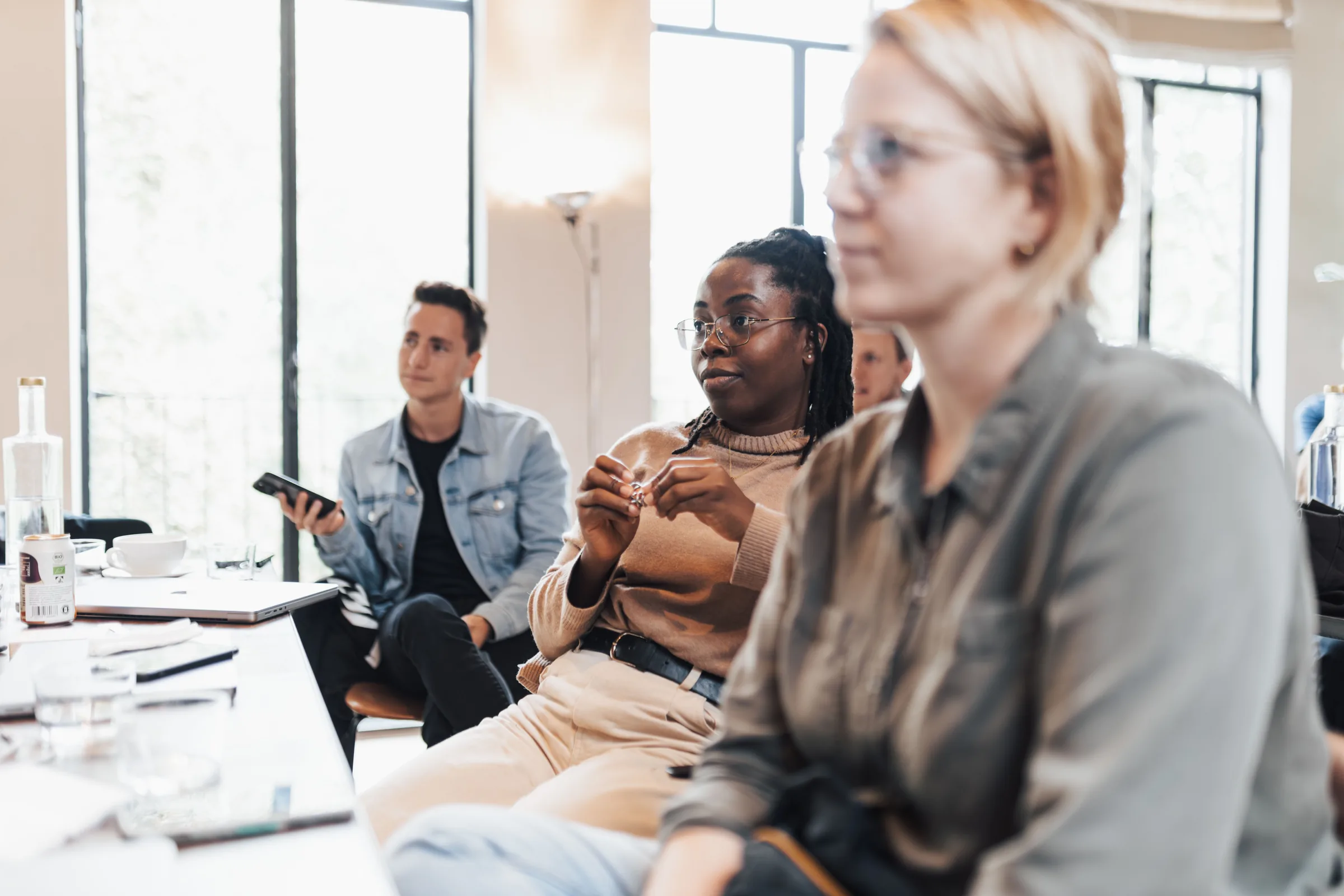 Participants listening during a facilitated research discussion